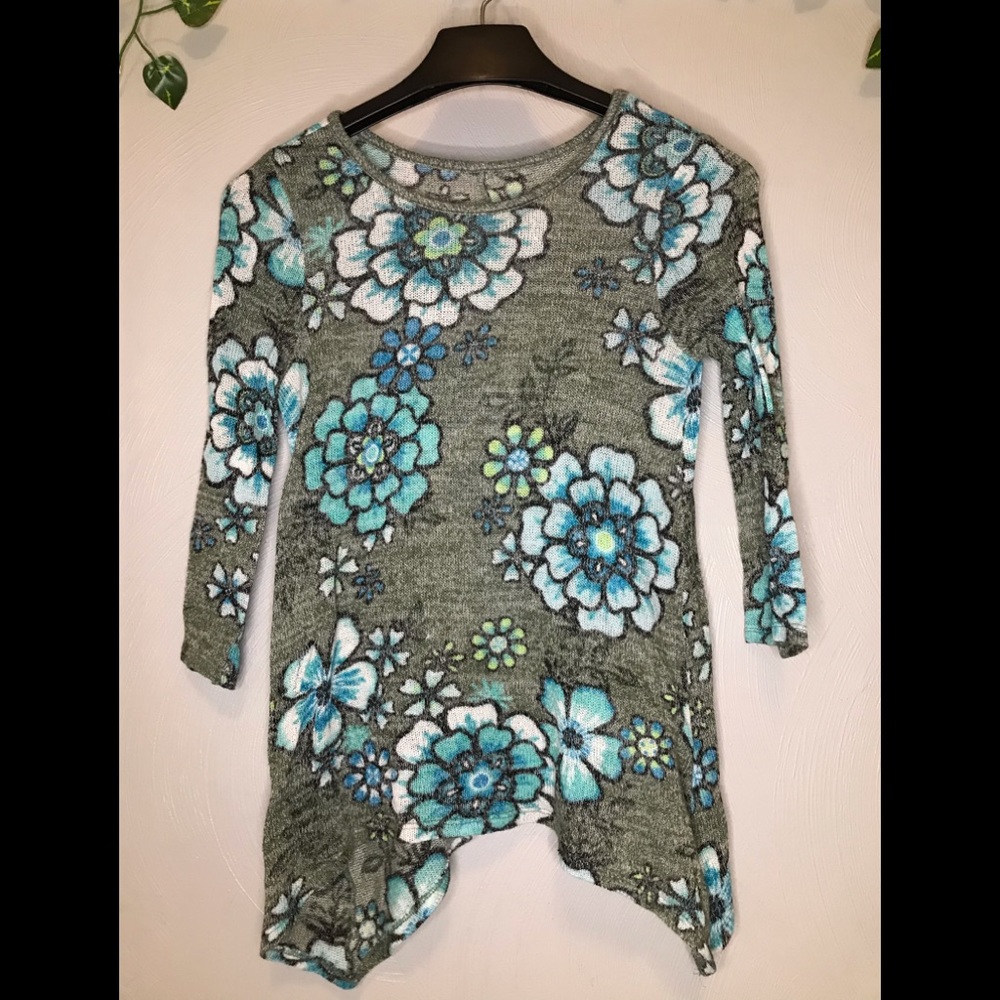 Gray and blue see-through shirt. Shark bite style.